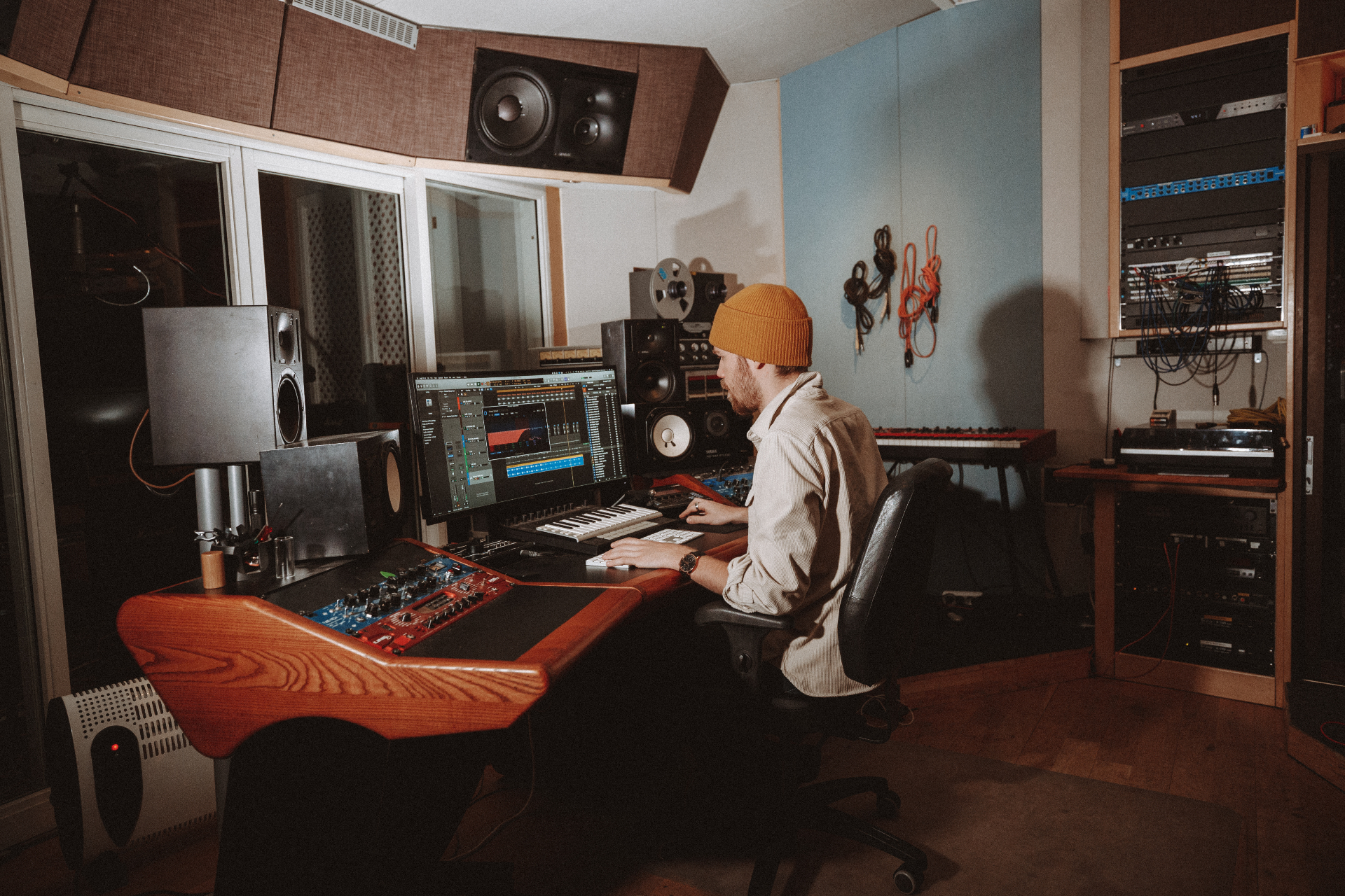 Vintage analog mixing console glowing gold in a Stockholm studio control room